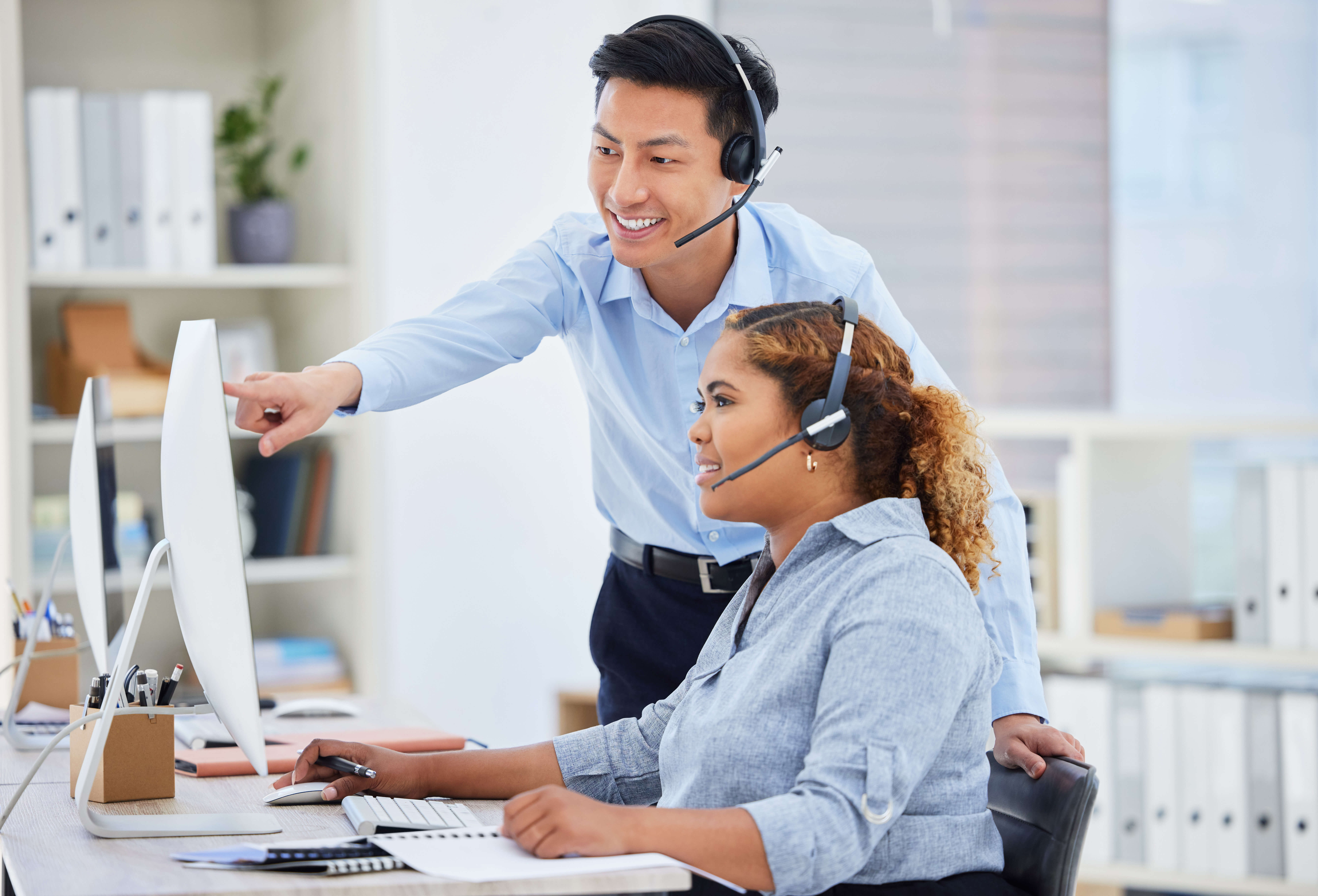 Customer support, training and manager with woman on computer for help, advice and assistance. Telemarketing, call center and female intern with Asian man boss for contact, crm service and consulting.
