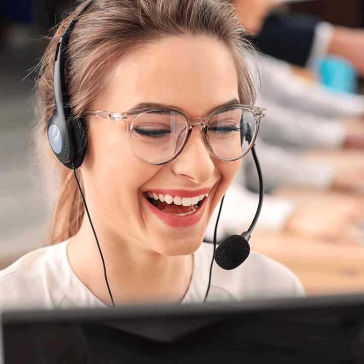 Smiling woman on the phone at a call center